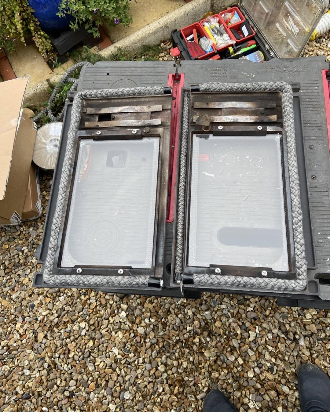 A pair of stove doors on the bench during a repair
